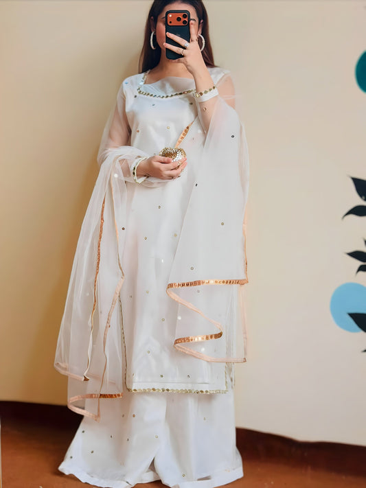 Jugnoo white organza dress with net dupatta draped over the shoulders, full length