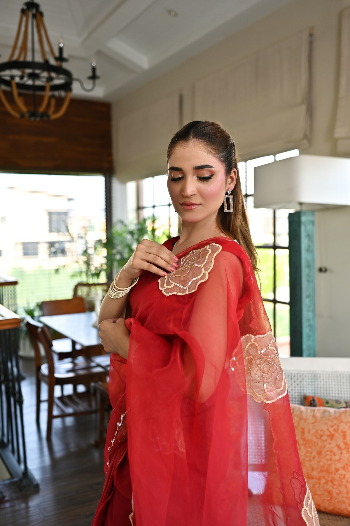 Laal Naz red organza saree featuring floral blouse embellishment and delicate hand-finished details