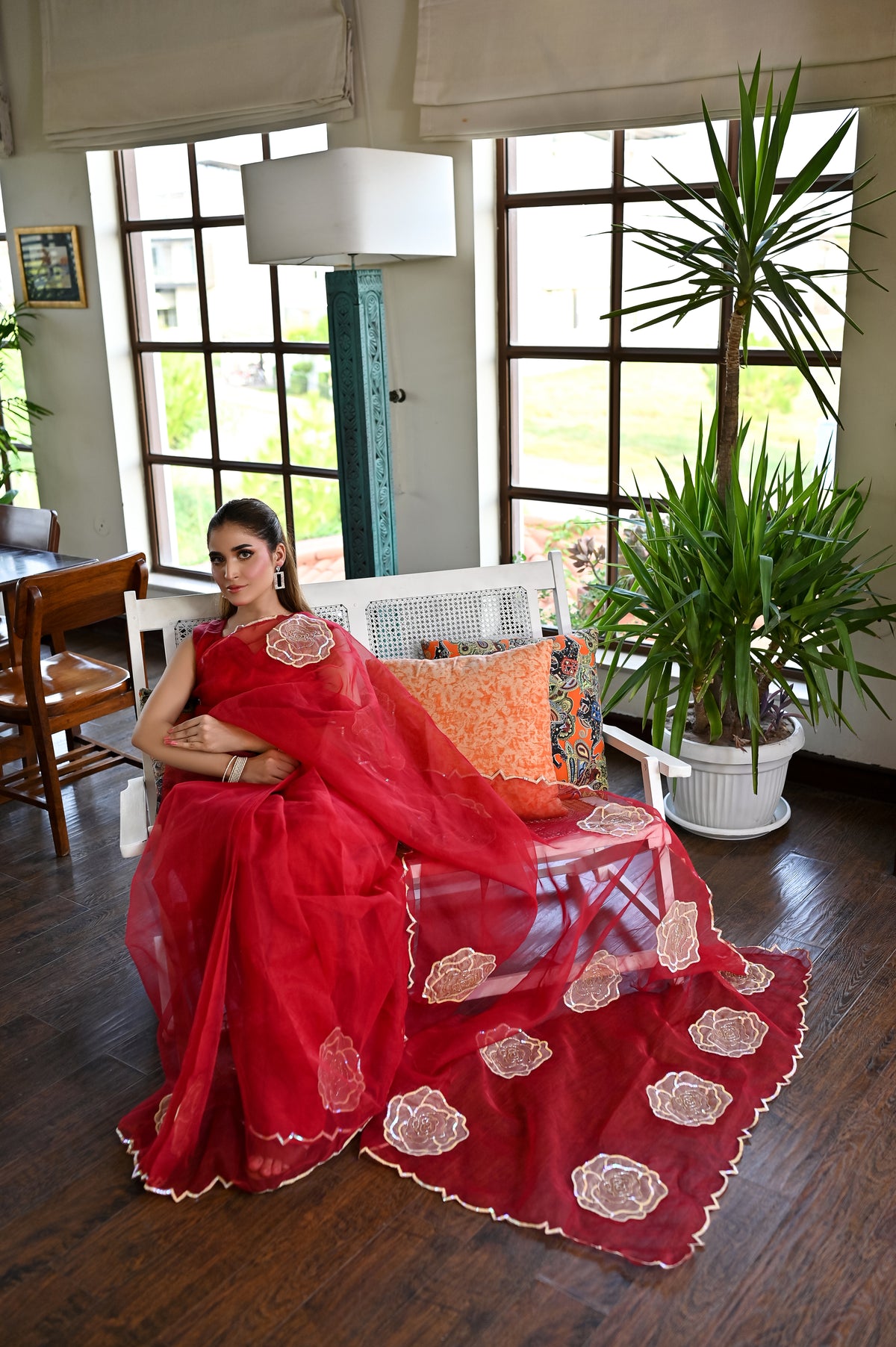 Laal Naz red organza saree seated with flowing sheer pallu and floral applique border