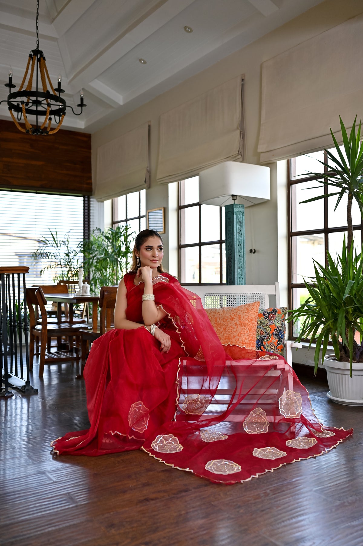 Laal Naz red organza saree displayed in a full drape view with statement border detailing