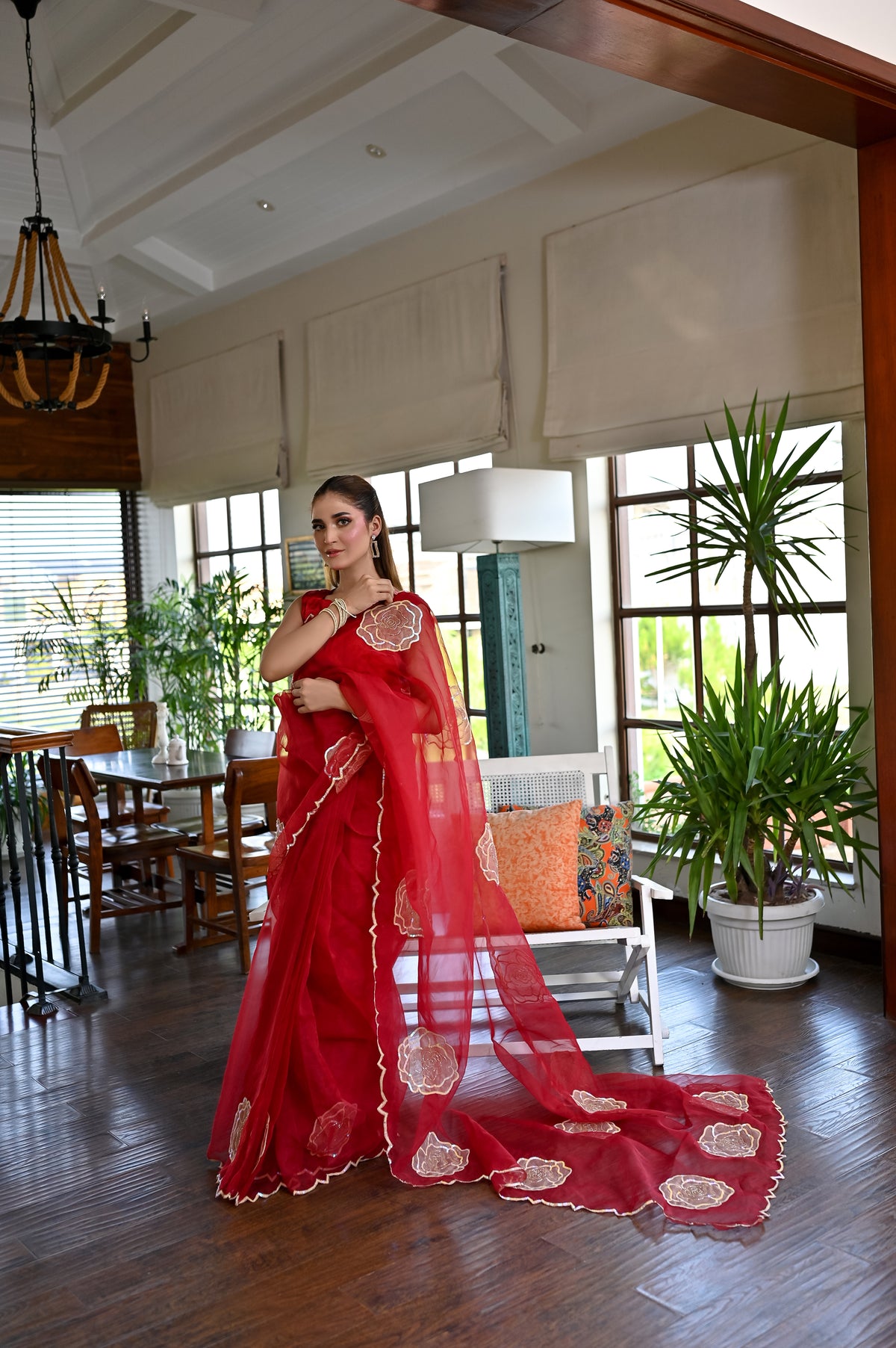 Laal Naz scarlet organza saree with embellished border, sequin detailing and flowing pallu