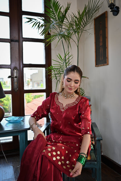 Shah Gul crimson Shesha silk suit featuring handmade cutdana and sequin neckline detailing