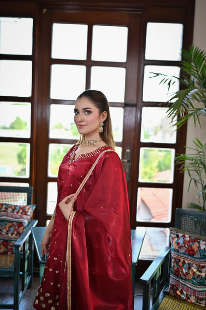 Shah Gul deep red Shesha silk ensemble styled with matching dupatta and handcrafted embellishments