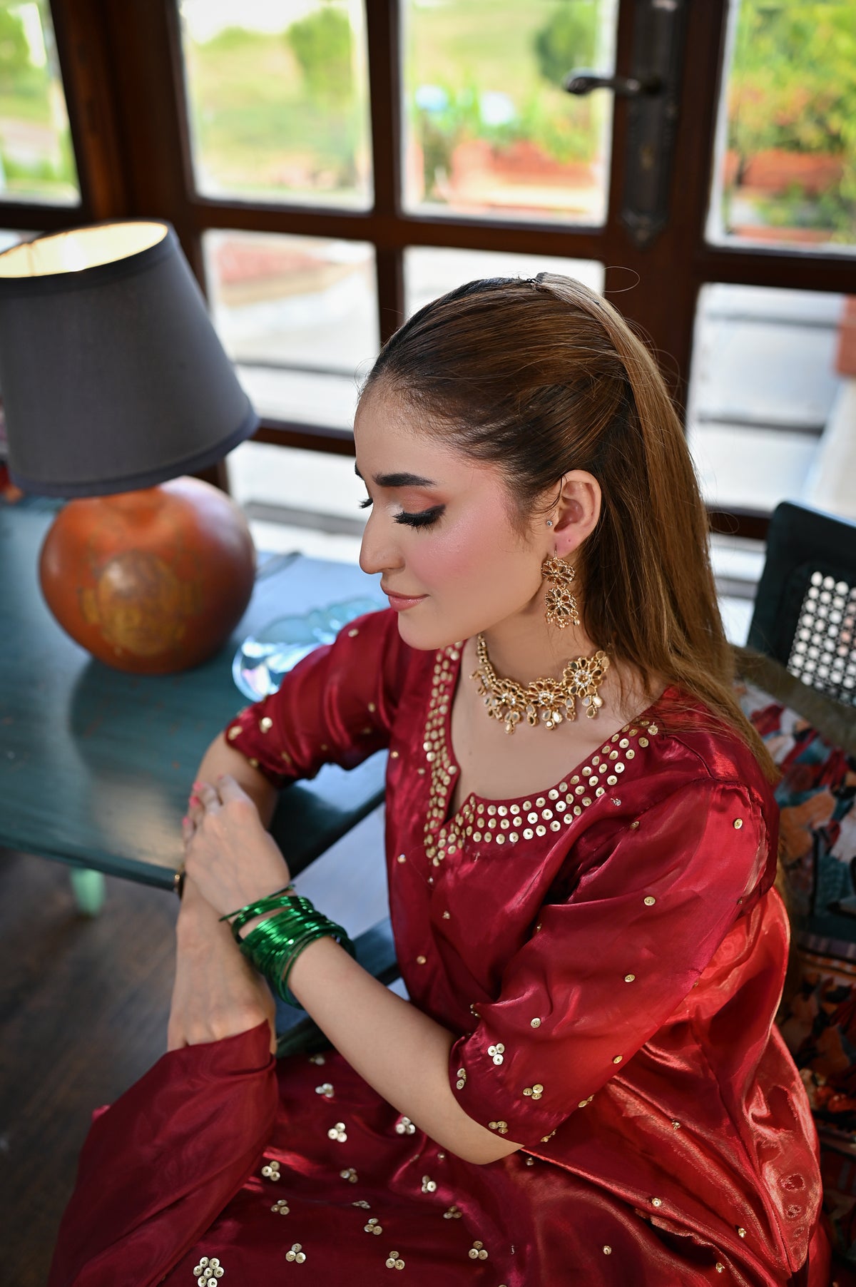 Shah Gul maroon Shesha silk outfit showcasing handcrafted neckline and sleeve embellishments