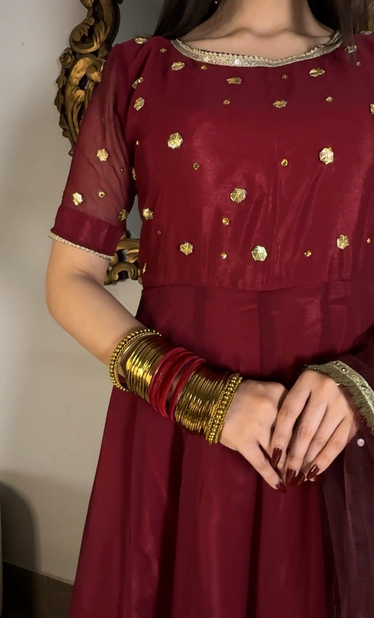 Aatish burgundy chiffon frock highlighting the gold gota motifs, round neckline and fitted waist detailing