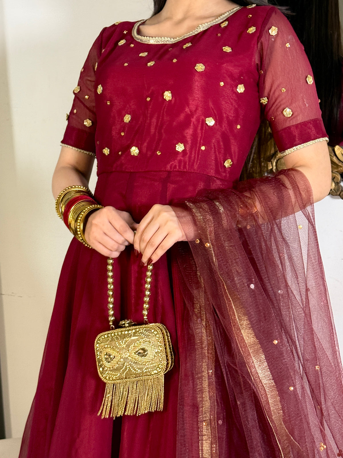 Detail shot of Aatish maroon chiffon frock with golden gota embellishment and sheer net dupatta