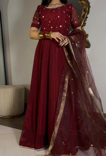 Aatish maroon kalidar frock styled with a sheer net dupatta and golden border detailing