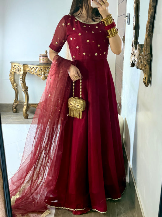 Maroon Aatish kalidar chiffon frock featuring golden gota accents, stone spray and a flowing formal silhouette