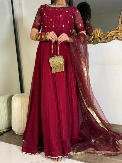 Full-length Aatish maroon kalidar outfit with scattered gold detailing and a softly draped net dupatta
