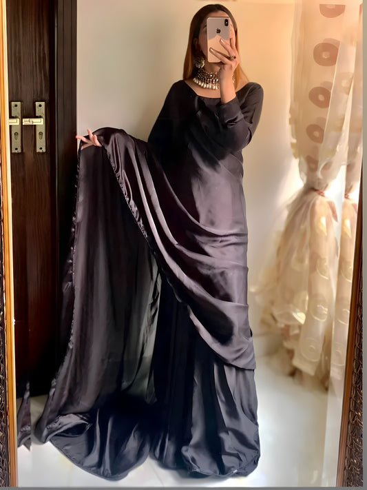 Anchal black shamoz silk saree with pallu held in hand, full length front view
