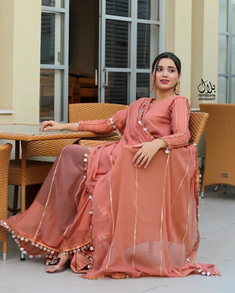 Aster Dusty Rose chiffon saree in seated pose showing soft flowing drape and lace pallu detailing by Anabiyawear