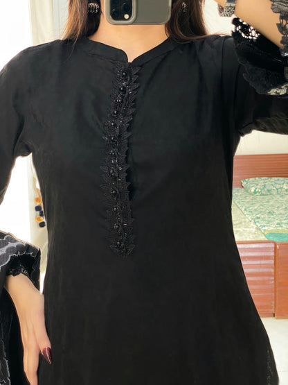 Close-up of Black Aura black lawn shirt highlighting the fancy lace neckline, front detailing and neat stitched finish