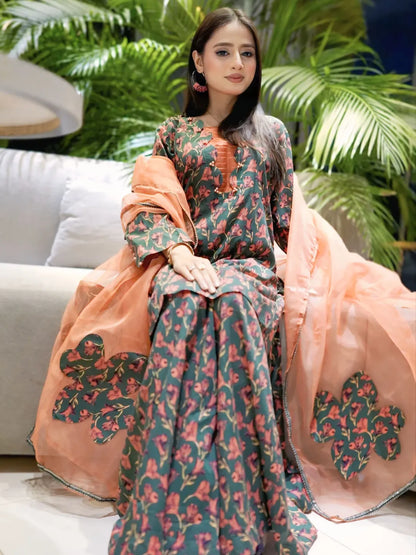 Breeze Charm printed lawn palazzo suit in seated front view with peach organza applique dupatta by Anabiyawear