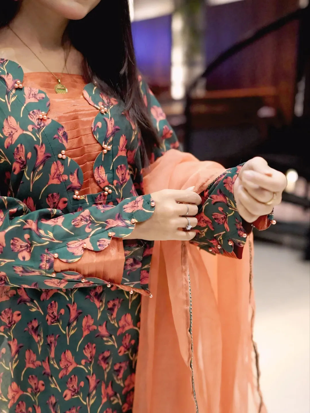 Breeze Charm printed lawn suit close-up showing sleeve pattern and peach organza dupatta by Anabiyawear