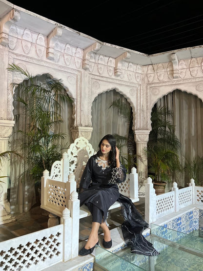 Bulbul Black Katan silk 3 piece in a seated pose with embellished sleeves, crystal accents and organza dupatta
