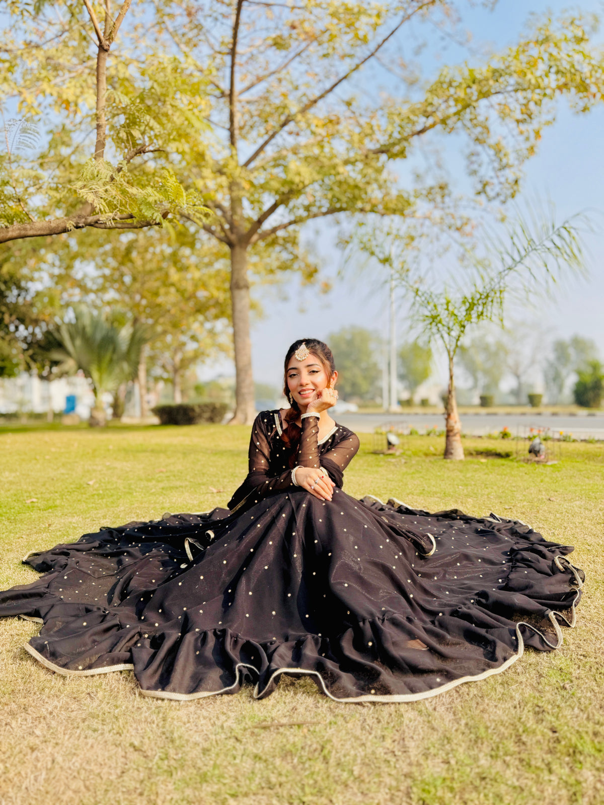 Jhomer dark frock in seated pose showing wide 12-yard flare and silver mukesh work by Anabiyawear