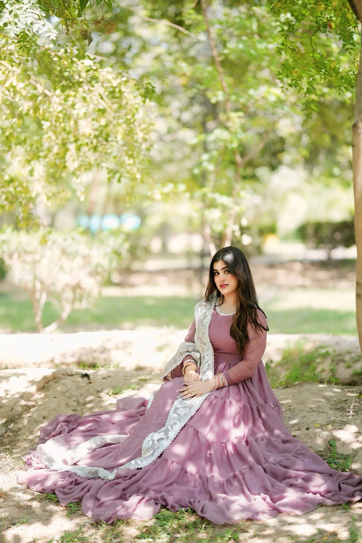 Leela Mauve chiffon step frock in a seated outdoor pose showcasing the wide layered flare and soft flowing fabric