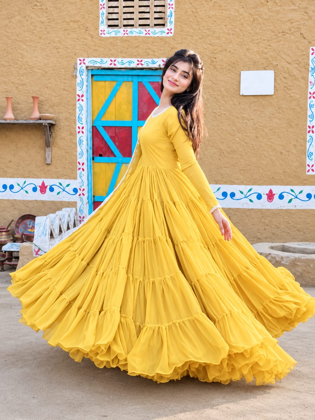 Leela Yellow chiffon step frock in twirl pose showing wide layered flare by Anabiyawear