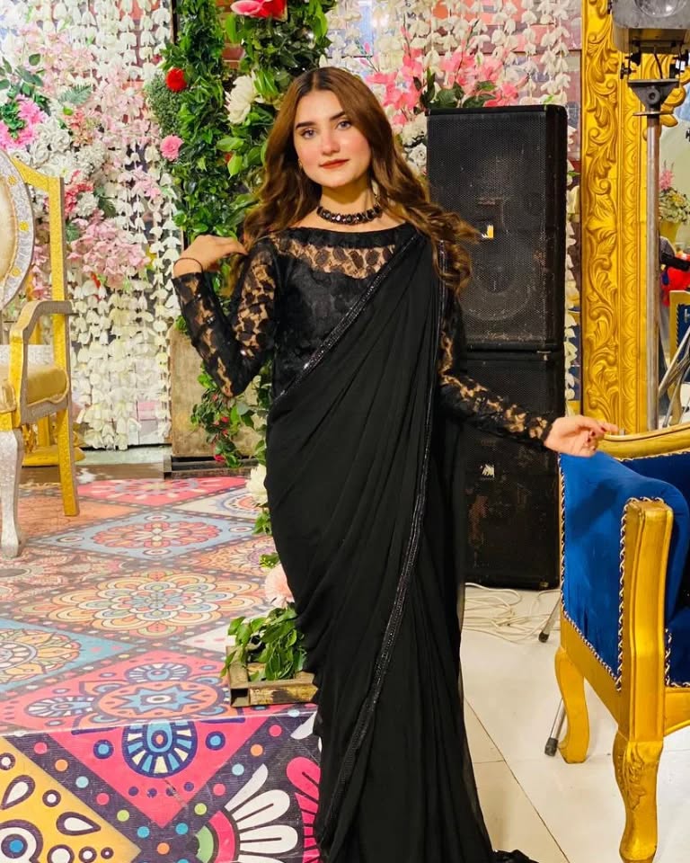 Lobelia black chiffon saree styled in a front drape pose with floral lace sleeves and matching net blouse