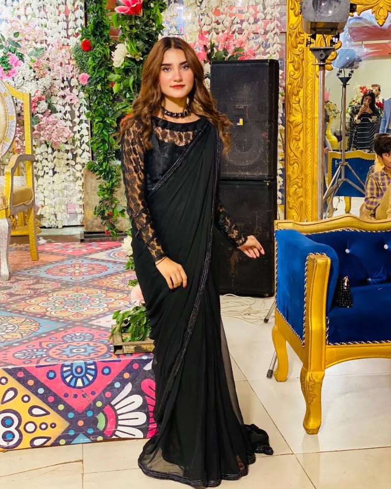 Lobelia black chiffon saree in a standing pose with smooth drape, lace sleeves and matching blouse
