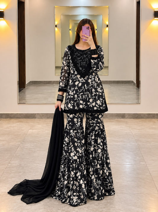Full length front view of Midnight Bloom black printed lawn sharara set with short shirt, wide flared bottom and chiffon dupatta