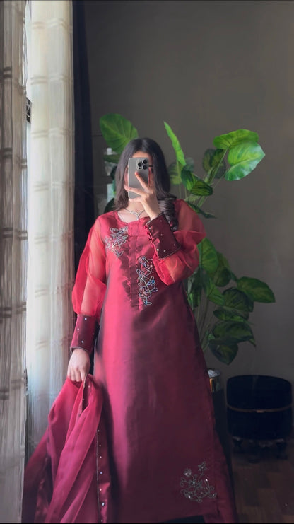 Murraya Maroon China katan silk three piece suit in a mirror pose with crystal chain motifs, long shirt and organza dupatta