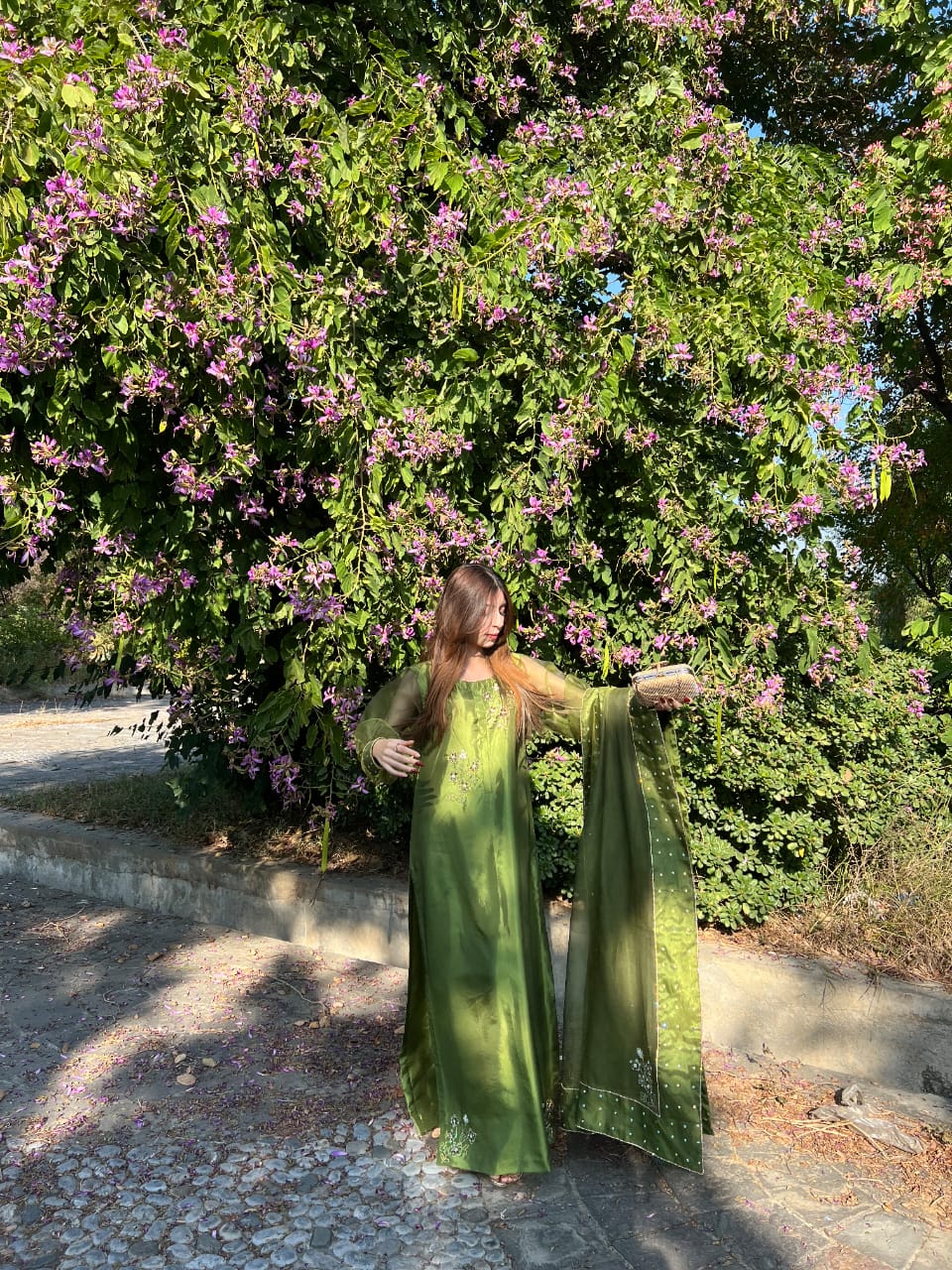 Murrayya leaf green festive suit showcasing the organza dupatta spread and embellished hem details