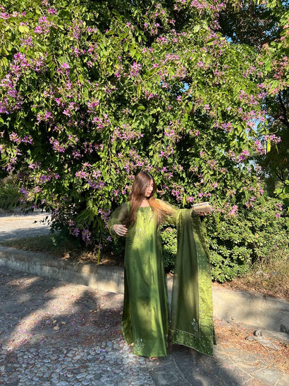 Murrayya leaf green festive suit showcasing the organza dupatta spread and embellished hem details