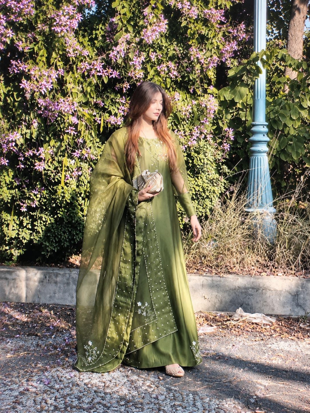 Murrayya leaf green 3 piece shown in a full outdoor look with organza dupatta, crystal work and embellished hem