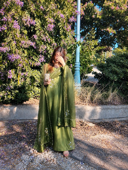 Murrayya leaf green 3 piece styled in a garden setting with a soft organza dupatta and detailed festive finish