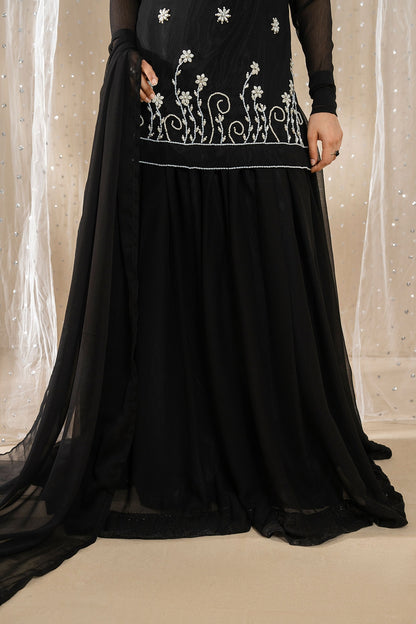 Front detail of Noir Zahra embroidered black chiffon shirt with flowing sharara