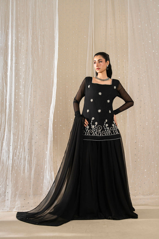 Model wearing Noir Zahra black embroidered chiffon sharara suit with matching dupatta
