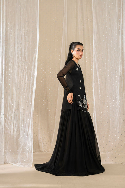 Side view of model wearing Noir Zahra black embroidered chiffon sharara suit