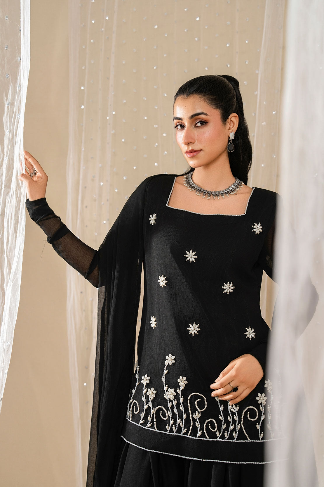 Model displaying Noir Zahra black embroidered chiffon shirt with matching sheer dupatta