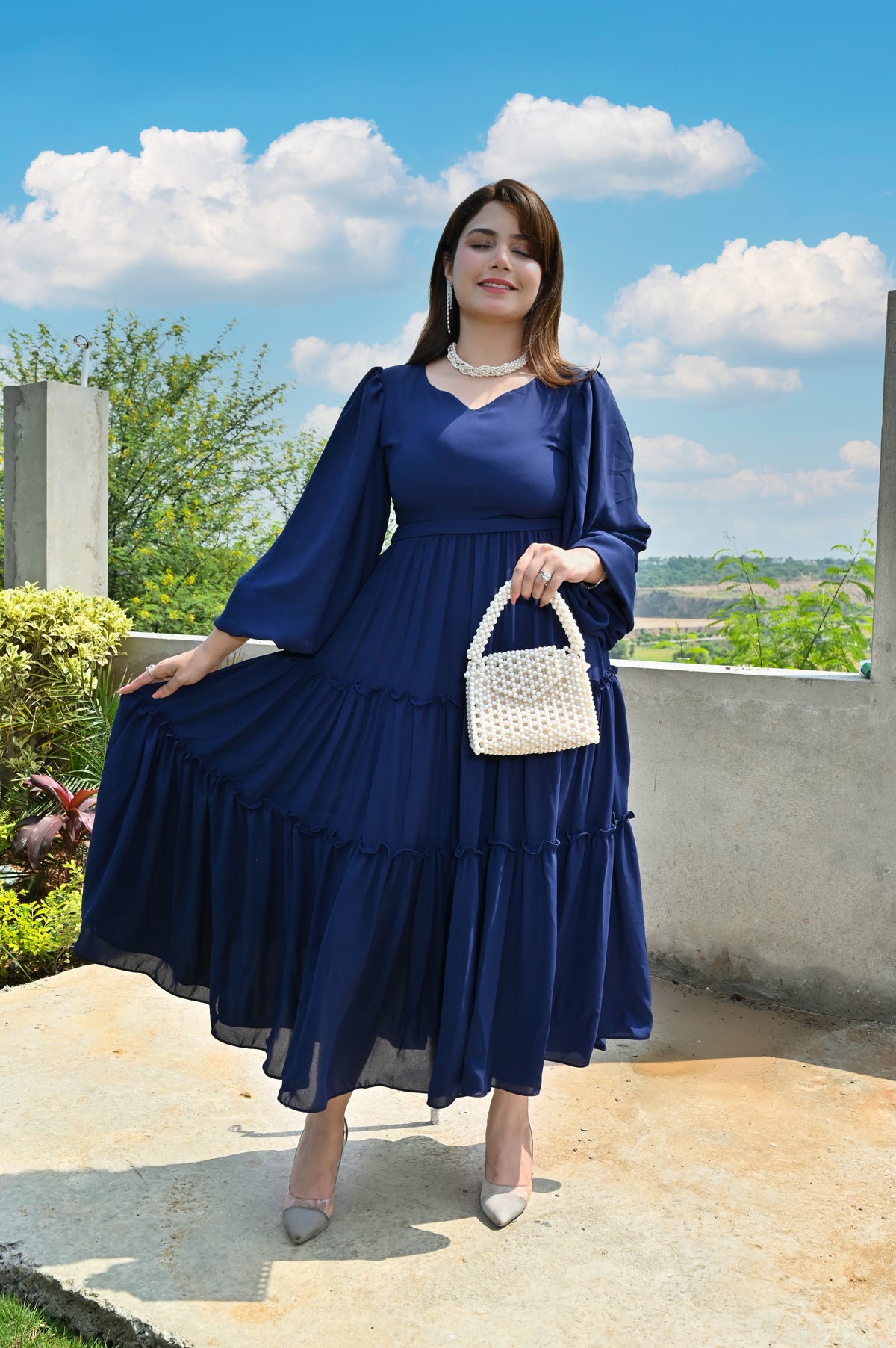 Ocean Muse navy blue georgette frock displaying its wide tiered flare