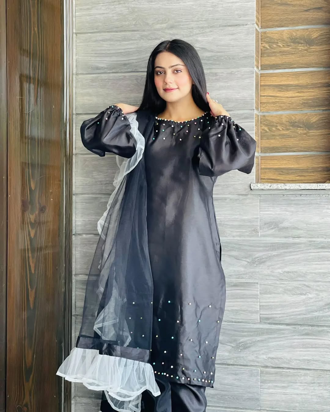 Pearl Black Katan silk capri set showing puff sleeves, pearl work and ruffle organza dupatta by Anabiyawear