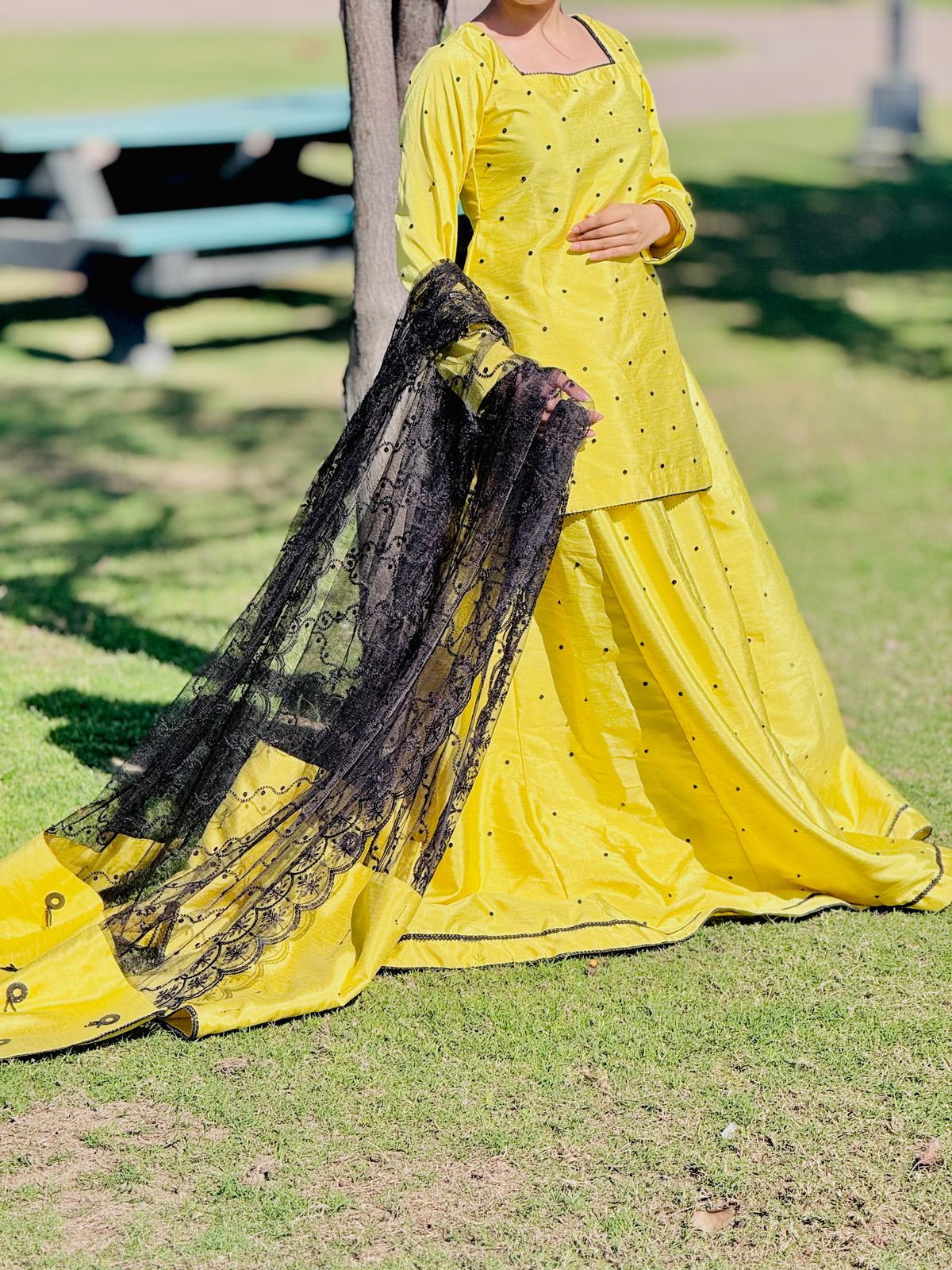Primrose yellow raw silk kalidar lehenga with black embroidered dupatta detail by Anabiyawear