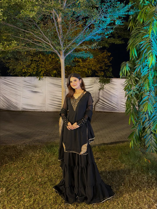 Rang-e-Shabnam black chiffon 3 piece gharara outfit photographed outdoors at a night event