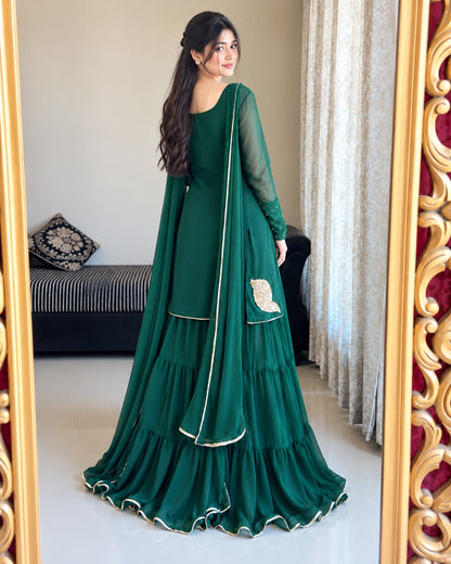Back view of Rang-e-Shabnam bottle green chiffon gharara set showing the flowing four-layer bottom, sheer sleeves and long dupatta drape