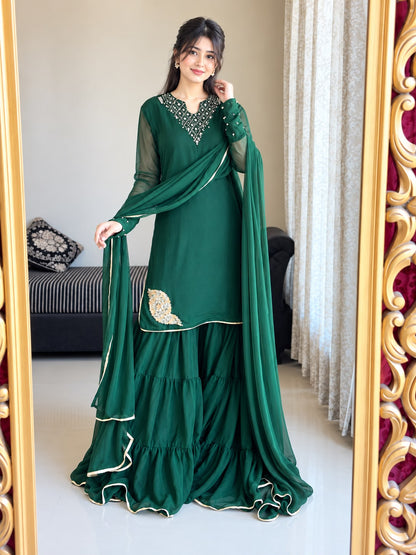 Front view of Rang-e-Shabnam bottle green pure chiffon gharara set with ring sleeves, four-layer gharara and lace finished dupatta