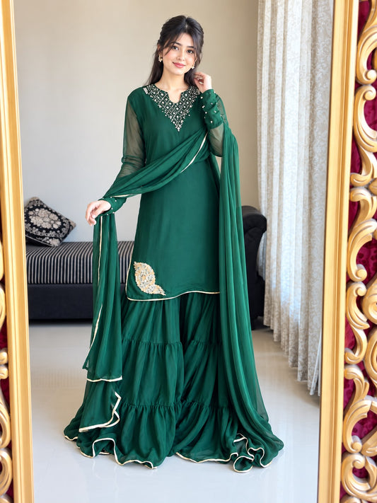 Front view of Rang-e-Shabnam bottle green pure chiffon gharara set with ring sleeves, four-layer gharara and lace finished dupatta
