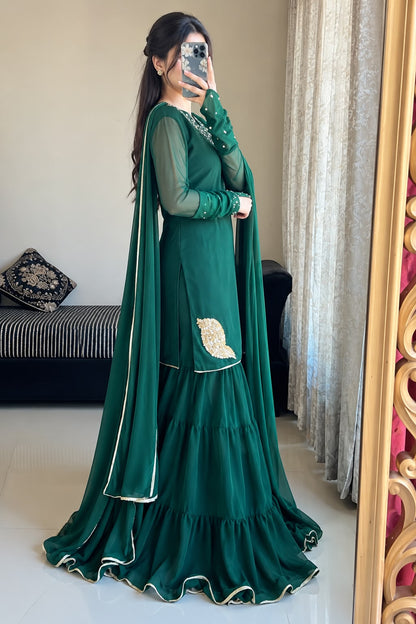 Side profile of Rang-e-Shabnam bottle green pure chiffon gharara set showing layered gharara, ring sleeves and long lace-edged dupatta