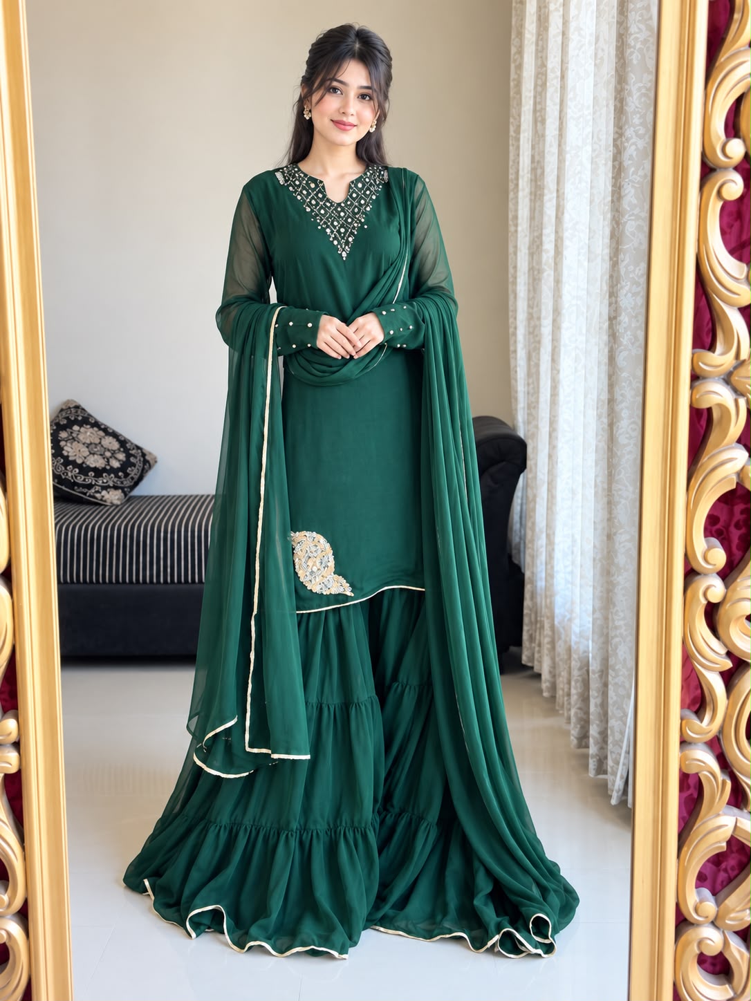 Full-length indoor view of Rang-e-Shabnam bottle green chiffon set featuring embellished neckline, four-layer gharara and long lace-finished dupatta