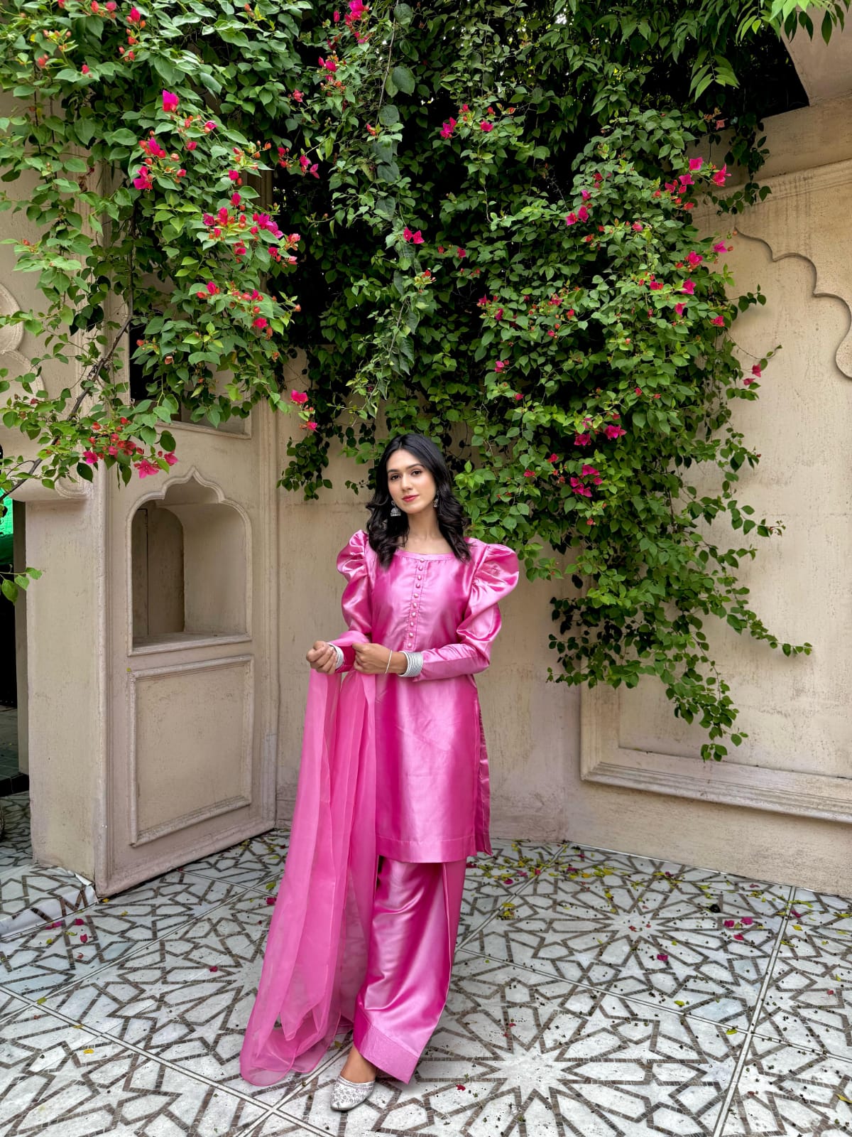 Full front view of Rose Pink China Katan 3 piece with straight shirt, fluffy sleeves, farshi trouser and organza dupatta in an outdoor setting