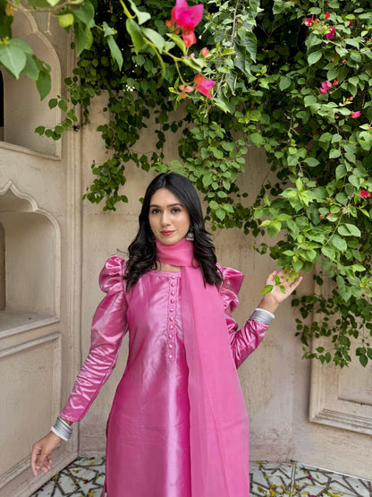 Upper-body outdoor view of Rose Pink China Katan shirt showing puff sleeves, front design and soft silk finish against a leafy backdrop