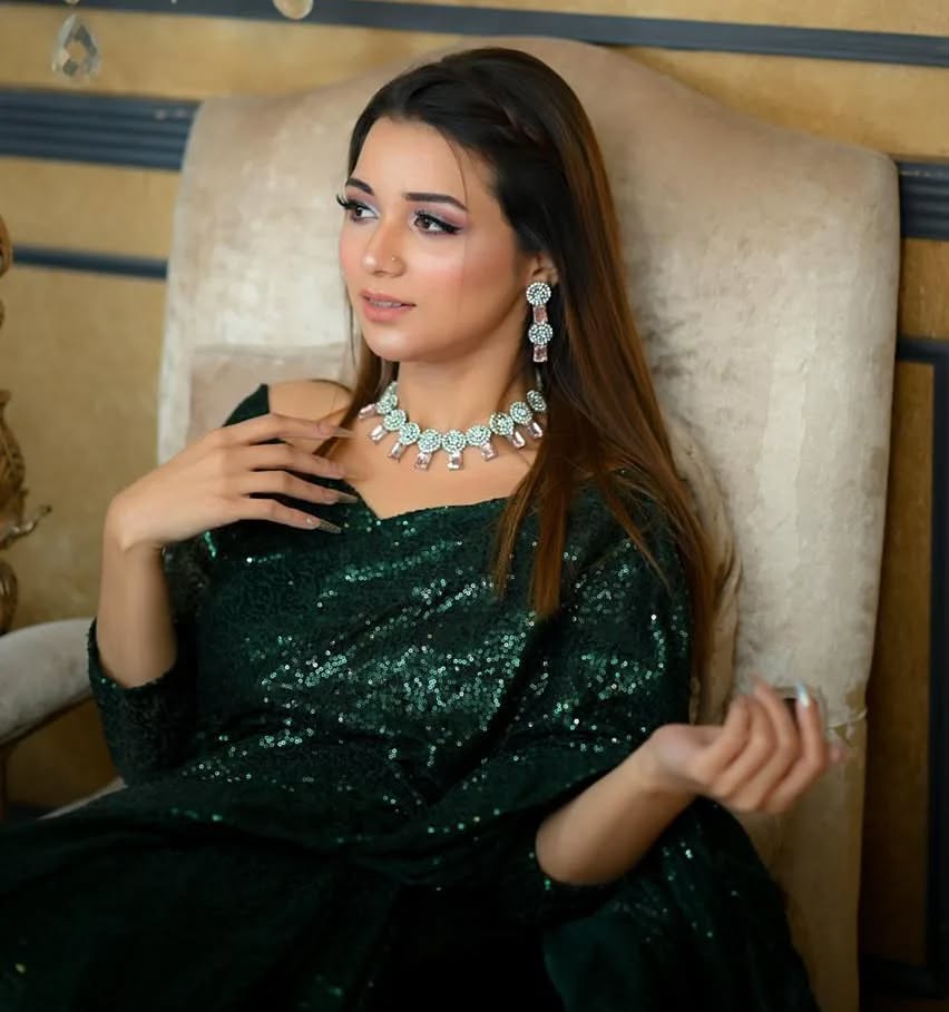 Snowdrop Bottle Green sequin net saree in portrait pose with draped pallu and embellished blouse by Anabiyawear