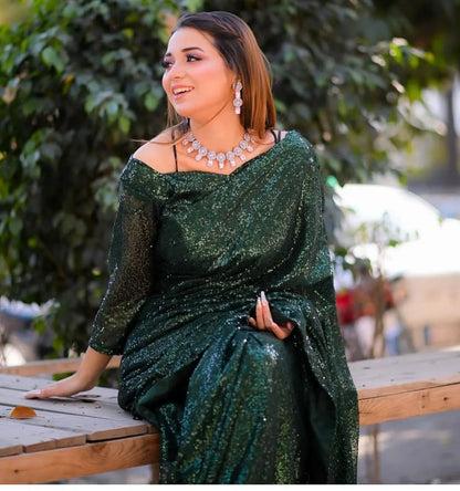Snowdrop Bottle Green sequin net saree in seated pose with full-sleeve blouse by Anabiyawear
