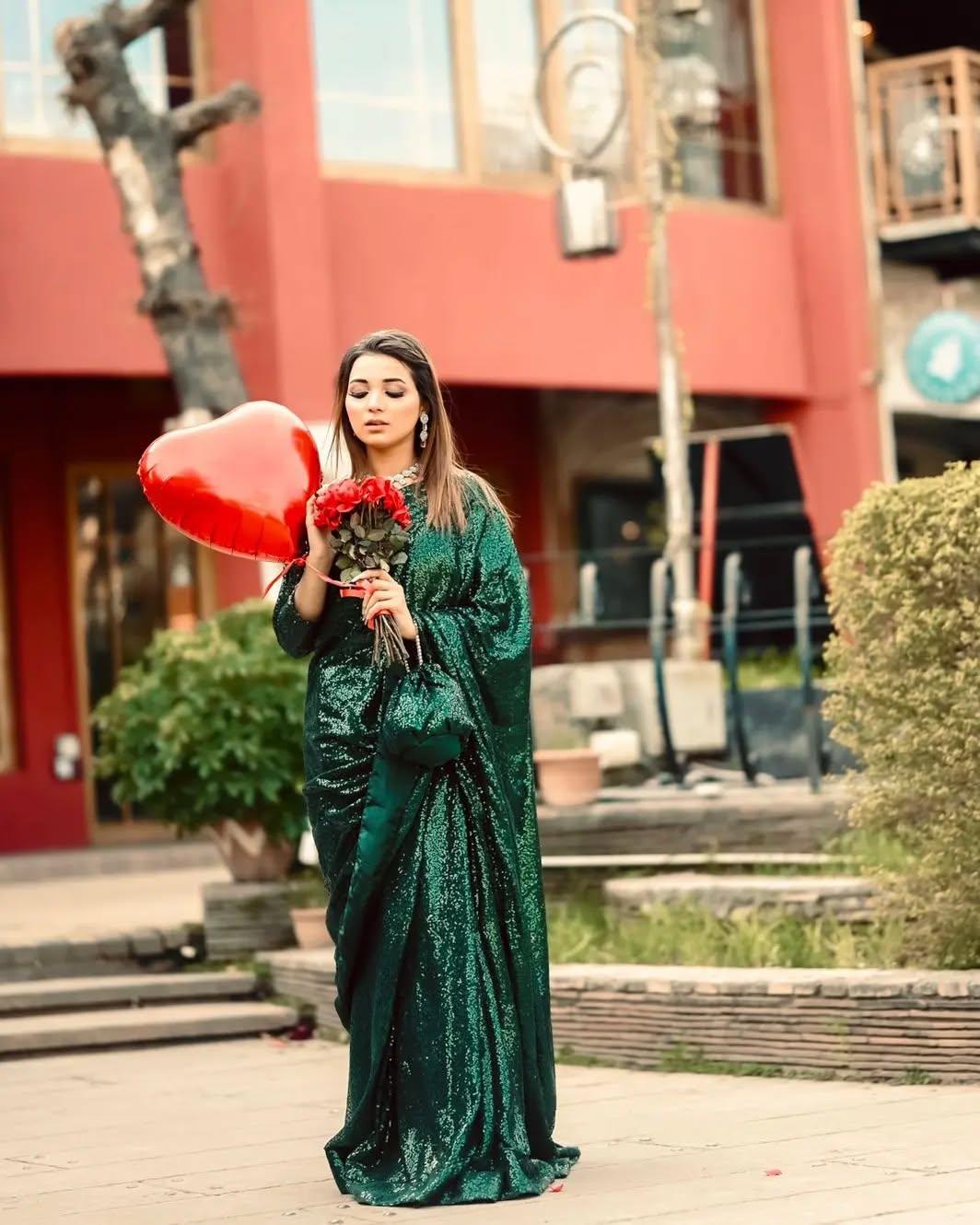 Snowdrop Bottle Green sequin net saree in full-length outdoor pose with flowing drape by Anabiyawear