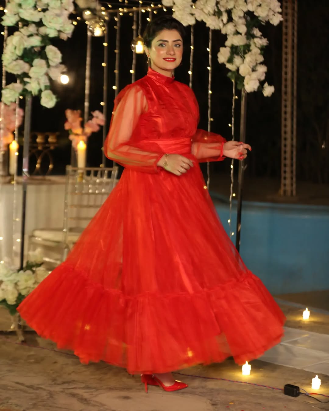 Valentine red Bareeza maxi in an evening pose with a wide skirt and sheer upper design