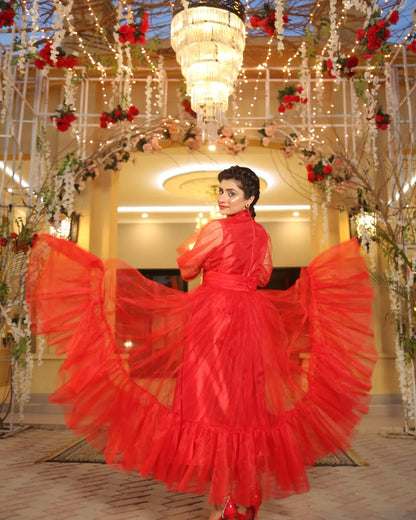 Back pose of Valentine red maxi highlighting the wide layered flare and flowing net design